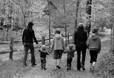 family walking in the woods