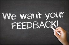Chalk board with hand writing “We want your feedback”